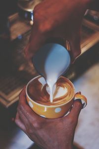 Close-up of hand holding coffee cup