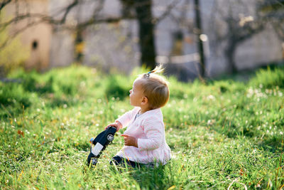 Cute girl sitting on grass outdoors