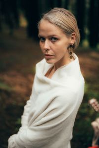 Portrait of young woman standing outdoors