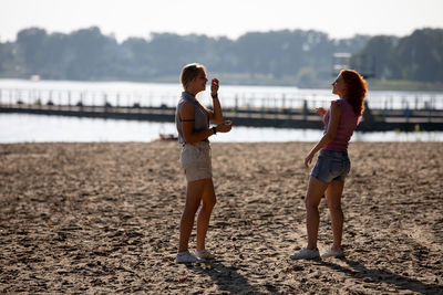 Rear view of couple standing on beach