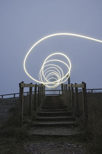 Staircase against sky at night