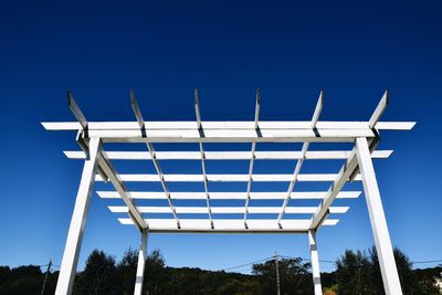 Low angle view of wind turbine against blue sky