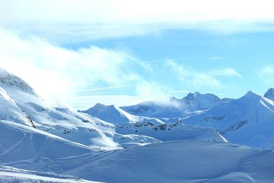 Scenic view of snowcapped mountains against sky