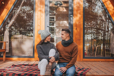 Couple sitting in park during winter