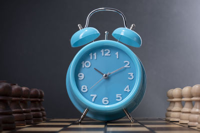 Close-up of clock against blue background