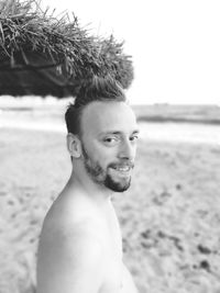 Portrait of shirtless man at beach