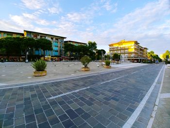 Street by building against sky