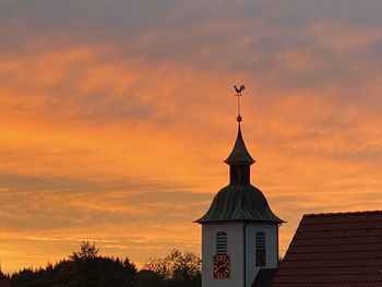 Silhouette building against sky during sunset