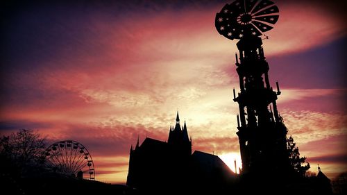 Low angle view of silhouette built structure against sky at sunset