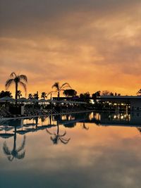 Scenic view of swimming pool against sky at sunset