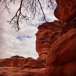 View of rock formation against cloudy sky