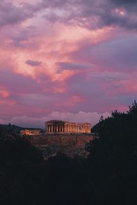 Buildings in city against sky during sunset