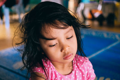 Close-up of cute sleepy girl at home