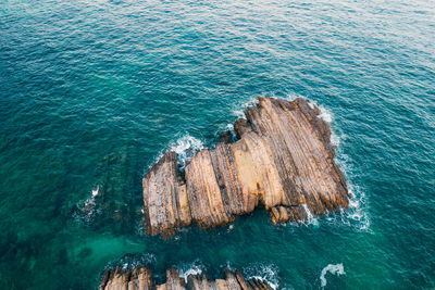 High angle view of rocks on sea