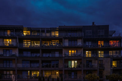 Low angle view of illuminated buildings against sky at night