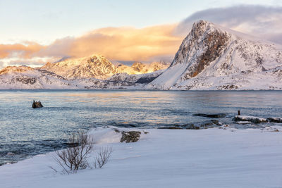 Scenic view of snowcapped mountains against sky during sunset