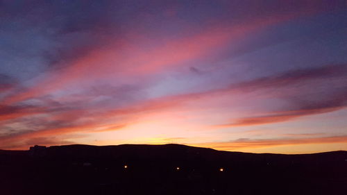 Silhouette of landscape against dramatic sky