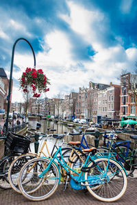 Bicycles on railing against buildings in city