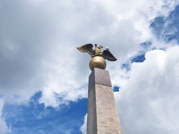 Low angle view of seagull statue against sky