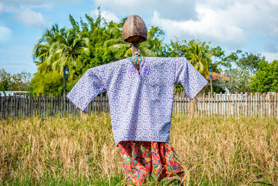 Rear view of person on field against sky