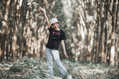 Portrait of man standing in forest