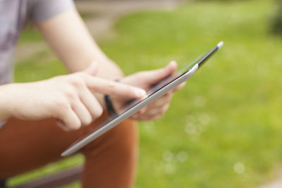 Midsection of woman using mobile phone