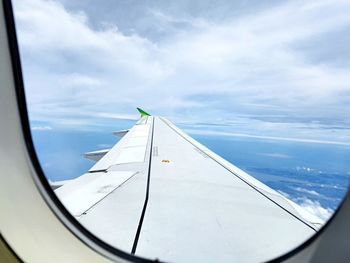 Cropped image of airplane wing against sky