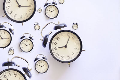 Directly above shot of alarm clocks on blue background