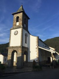 Low angle view of bell tower against sky