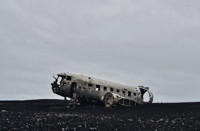 Airplane wreck at solheimasandur against sky