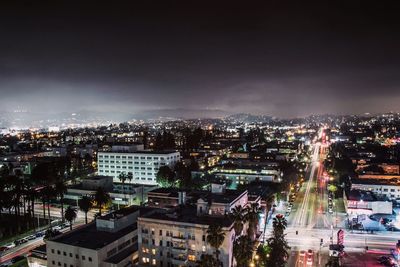 Aerial view of city lit up at night