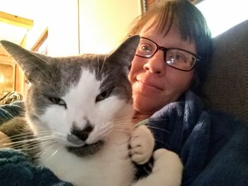 Portrait of young woman with cat