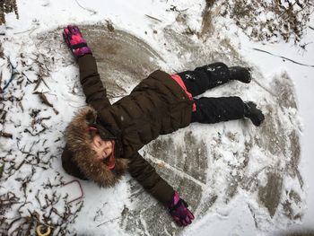 High angle view of person lying in snow