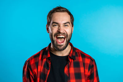 Portrait of a man against blue background