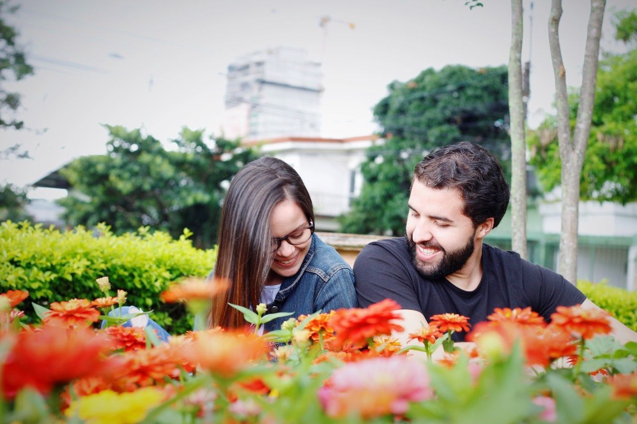two people, young adult, plant, young men, togetherness, real people, adult, couple - relationship, young women, bonding, flower, women, lifestyles, men, nature, leisure activity, selective focus, flowering plant, heterosexual couple, love, positive emotion, outdoors