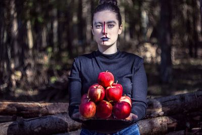 Portrait of man holding red apples