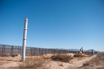 Low angle view of lighthouse against clear blue sky