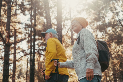 Rear view of woman standing in forest