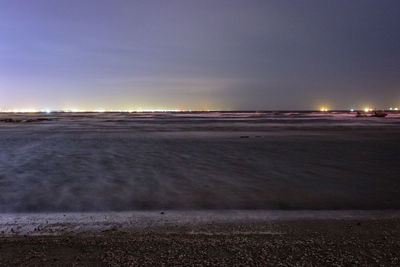 Scenic view of beach against sky at night