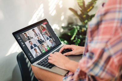 Midsection of woman using laptop