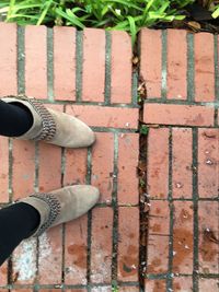 Low section of person standing on tiled floor