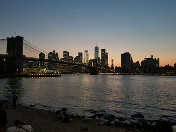 View of city at waterfront during sunset