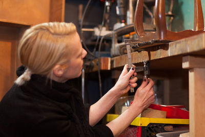 Side view of women working in workshop