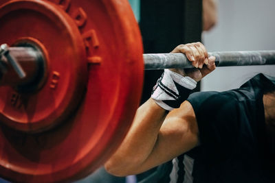 Midsection of man exercising in gym