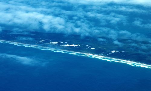 Aerial view of sea and airplane against sky