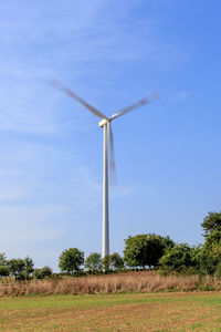 Windmill on field against sky