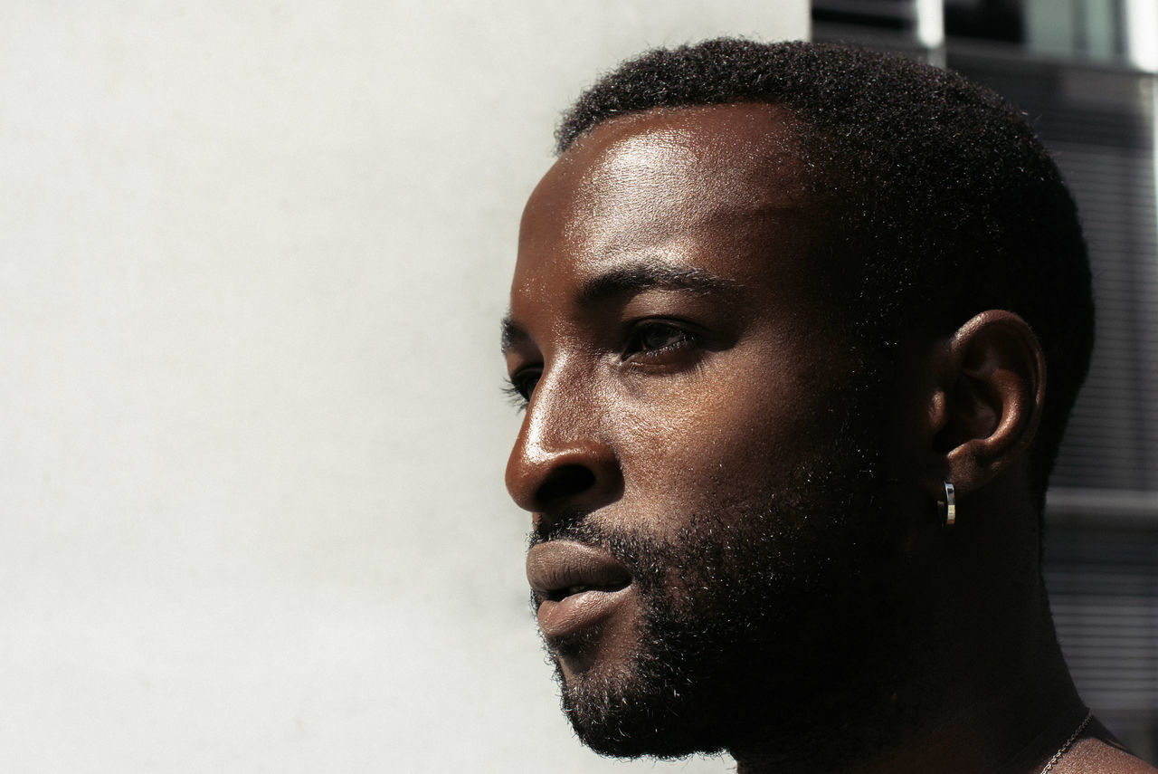 headshot, portrait, young adult, looking, indoors, one person, looking away, close-up, real people, young men, lifestyles, leisure activity, body part, facial hair, beard, human face, focus on foreground, contemplation, hairstyle, teenager