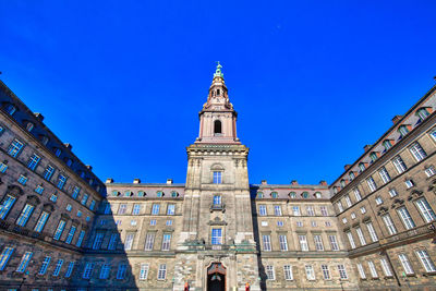 Low angle view of buildings against blue sky