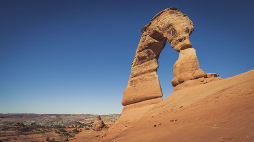 Rock formations against clear blue sky