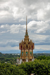 View of temple building against cloudy sky